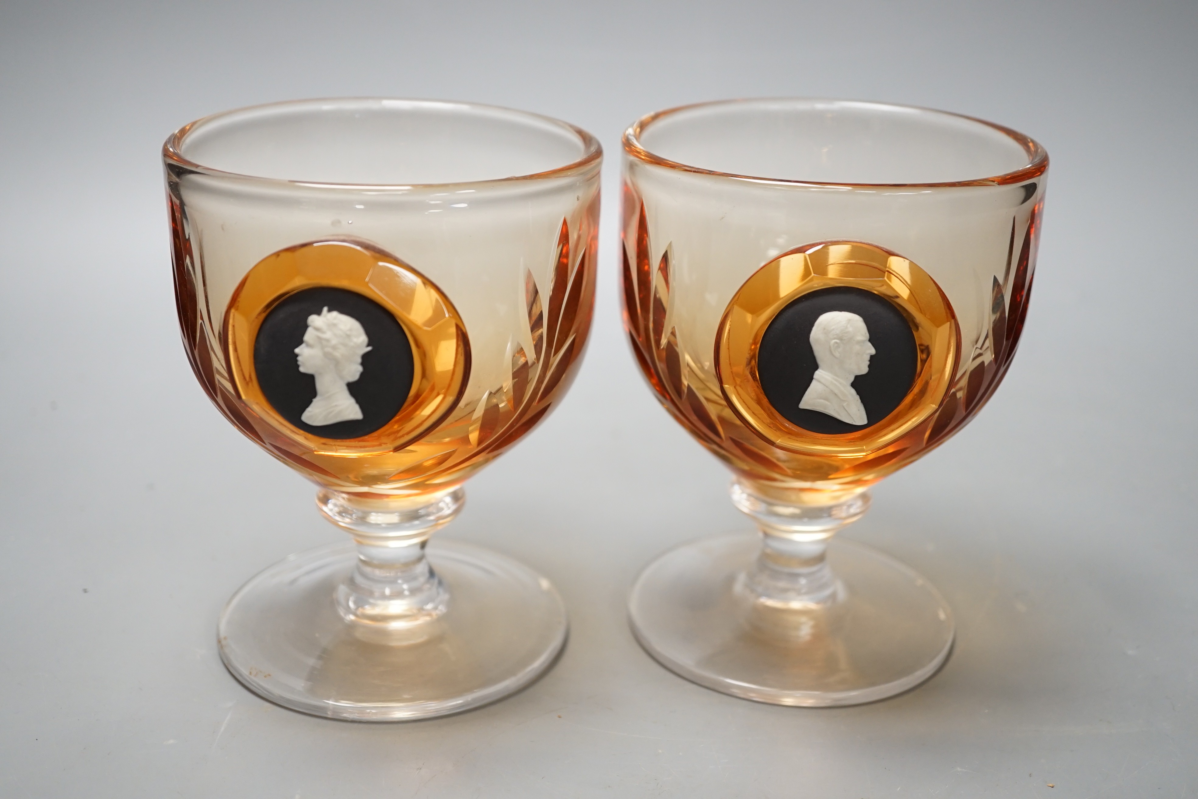 A pair of Wedgwood glass goblets with inset jasper commemorative plaques depicting QEII and Duke of Edinburgh, 13cms high